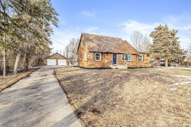 view of front of home featuring a garage and an outbuilding