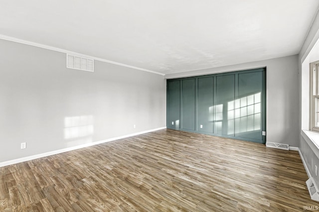 unfurnished room with hardwood / wood-style flooring