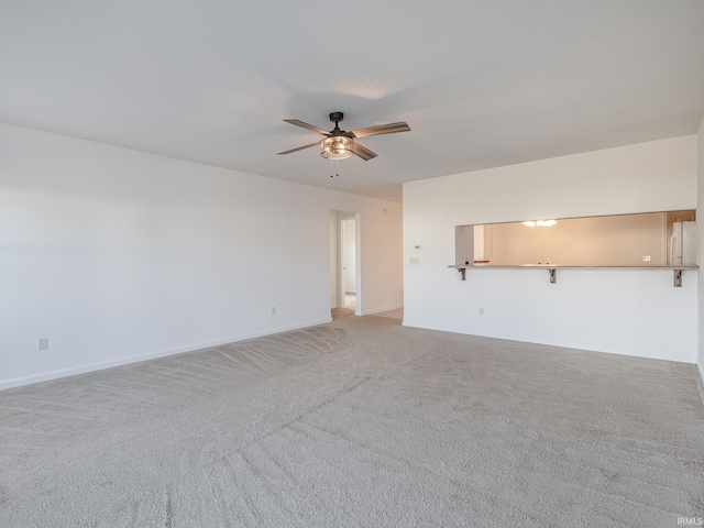 empty room featuring ceiling fan and light carpet