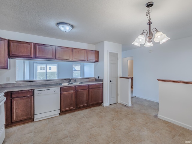 kitchen with sink, a chandelier, hanging light fixtures, white appliances, and a textured ceiling