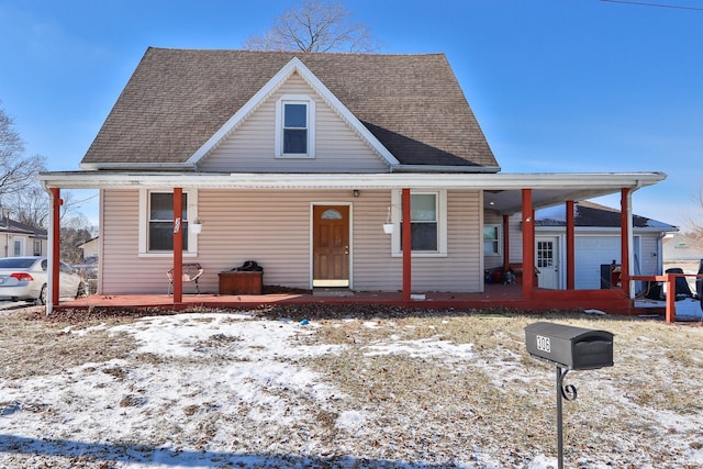 bungalow featuring a porch and a garage