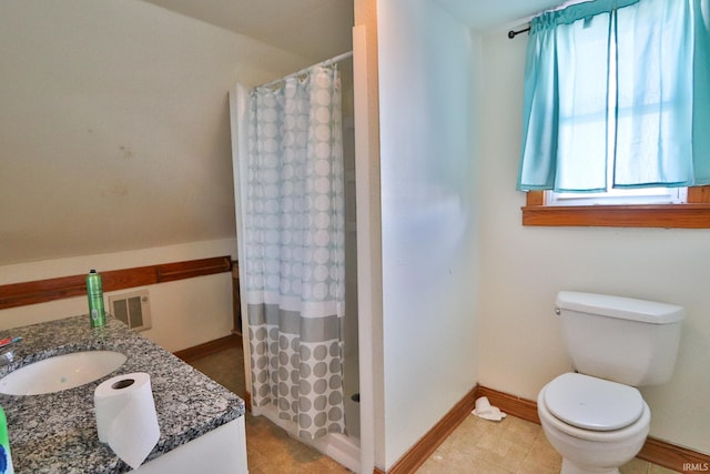 bathroom featuring vanity, toilet, and curtained shower