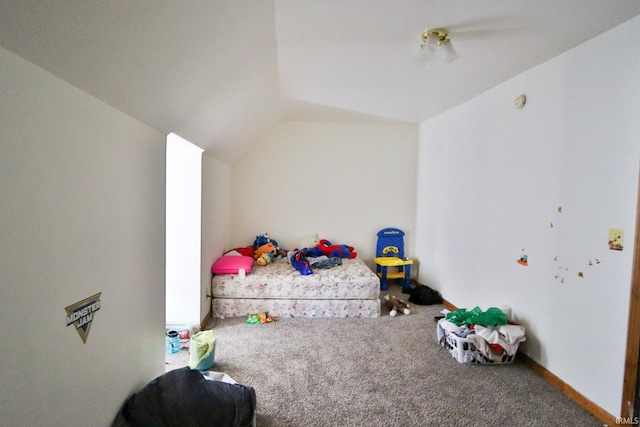 bedroom with lofted ceiling and carpet floors