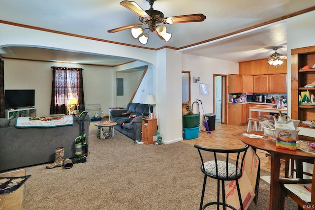 dining room with ceiling fan, ornamental molding, carpet flooring, and electric panel