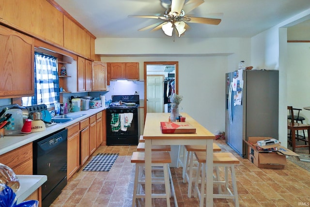 kitchen featuring ceiling fan, sink, and black appliances