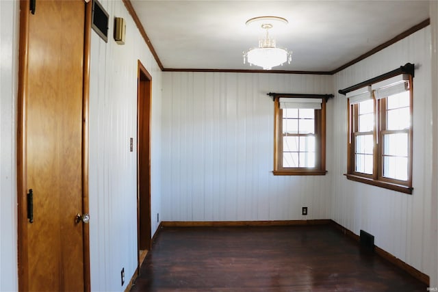 unfurnished room featuring ornamental molding and dark hardwood / wood-style flooring