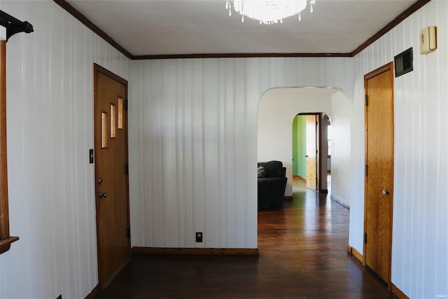 hallway featuring crown molding and dark wood-type flooring