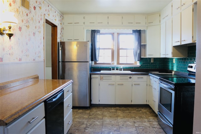 kitchen with stainless steel appliances, white cabinetry, and sink