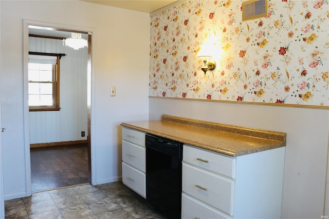 kitchen with black dishwasher and white cabinets