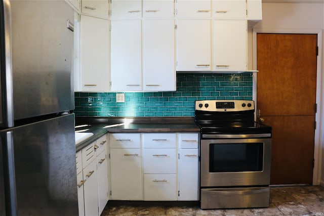 kitchen featuring stainless steel appliances, decorative backsplash, and white cabinets