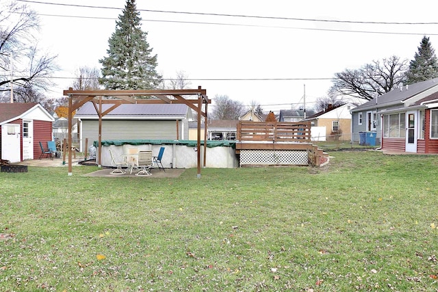 view of yard with a deck and a storage shed