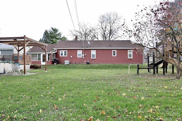 rear view of property with a lawn