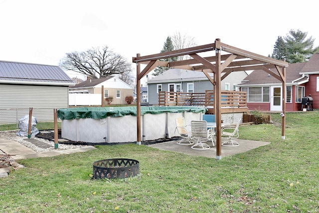 view of yard with a fire pit and a covered pool