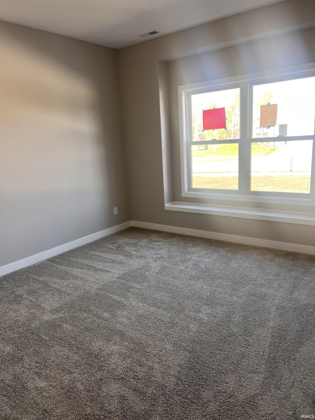 empty room with carpet flooring and baseboards