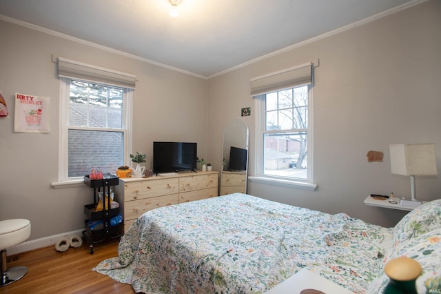 bedroom featuring crown molding and hardwood / wood-style floors