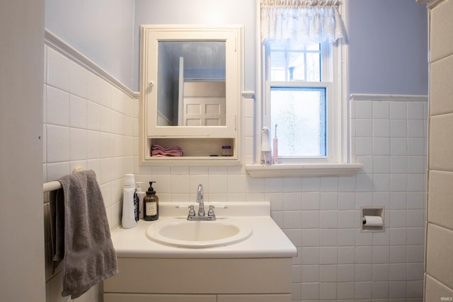 bathroom featuring vanity and tile walls