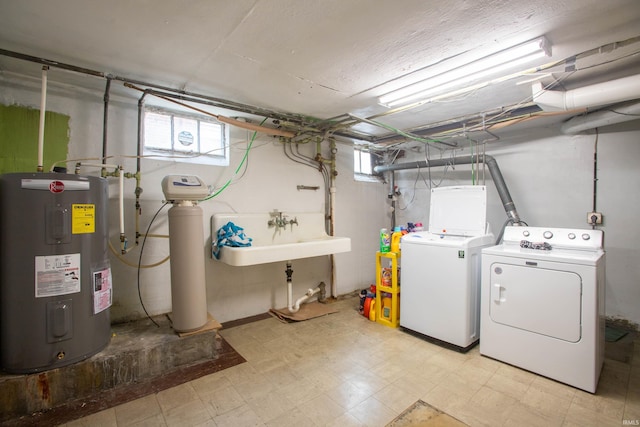 washroom featuring sink, separate washer and dryer, and electric water heater