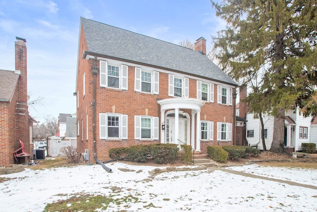 colonial-style house featuring cooling unit