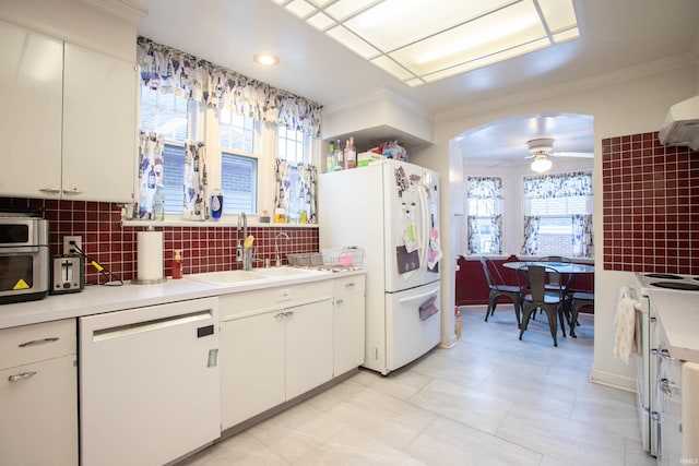 kitchen featuring tasteful backsplash, white appliances, and white cabinets