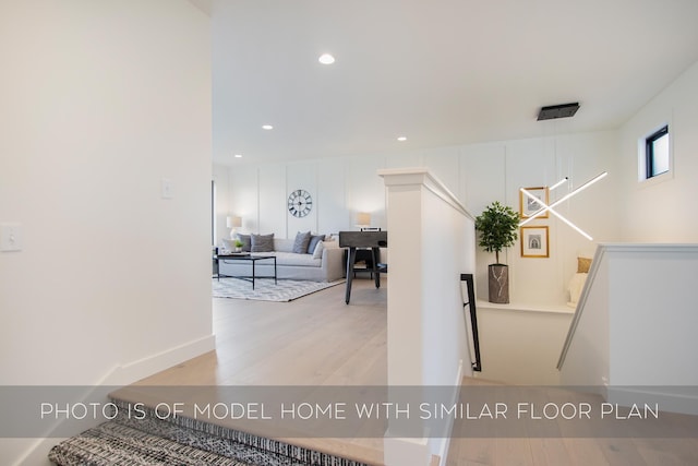 hallway with light hardwood / wood-style flooring