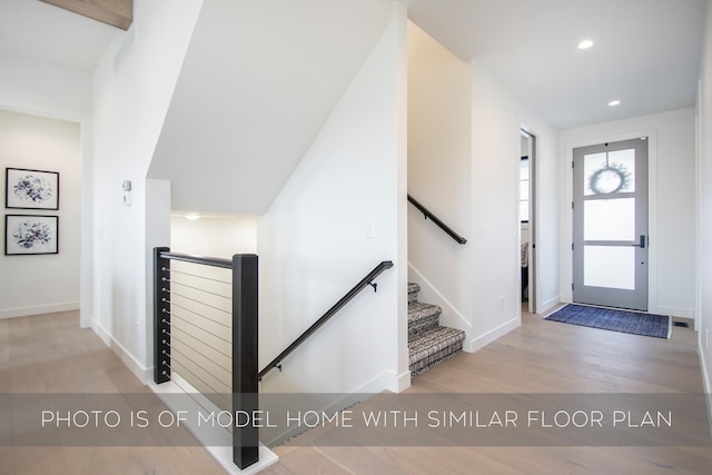 entryway with light wood-style floors, recessed lighting, and baseboards