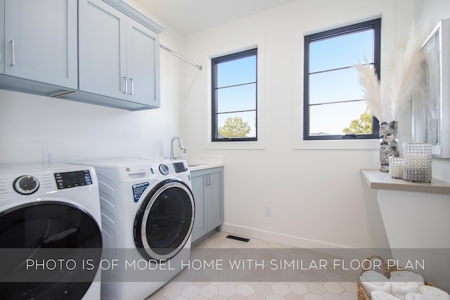 clothes washing area with cabinets, washing machine and dryer, sink, and light tile patterned flooring