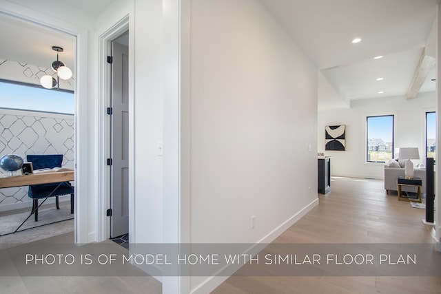 hall with light hardwood / wood-style floors and beamed ceiling