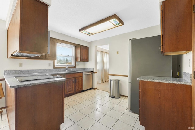 kitchen with sink, stainless steel appliances, and light tile patterned flooring