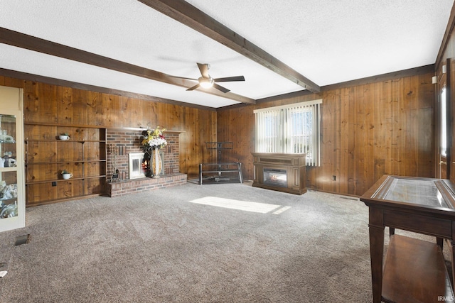 unfurnished living room featuring beam ceiling, a textured ceiling, and a fireplace