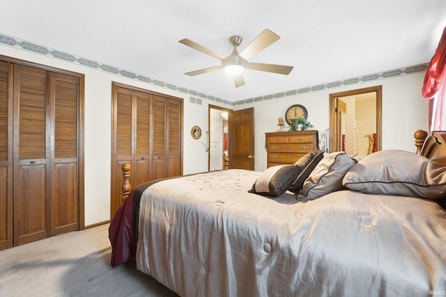 carpeted bedroom with multiple closets and ceiling fan