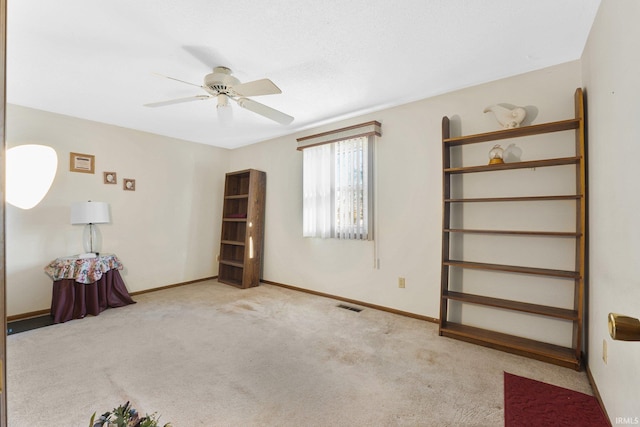 unfurnished bedroom with light colored carpet and ceiling fan