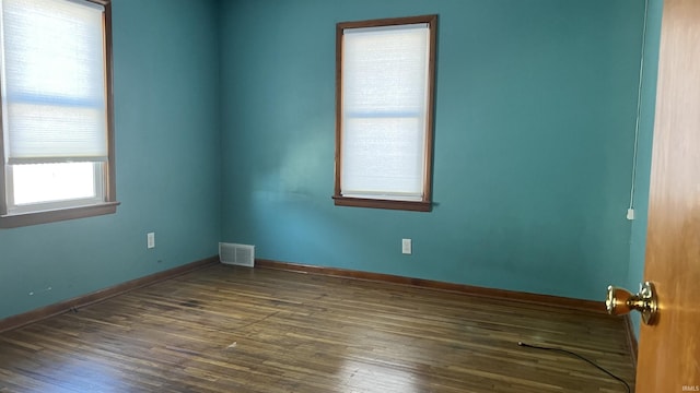 unfurnished room with dark hardwood / wood-style flooring