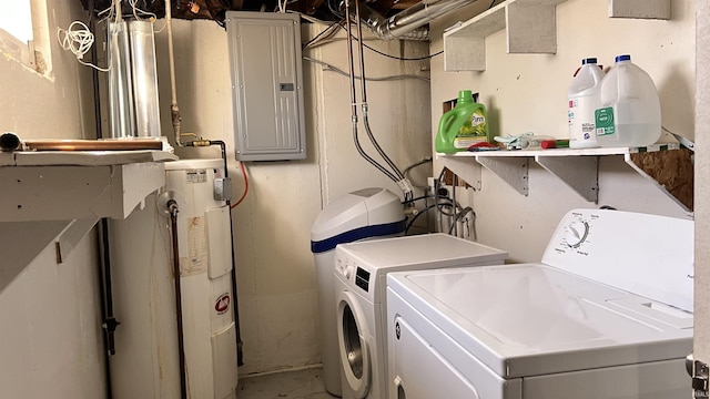 washroom with independent washer and dryer, electric panel, and water heater