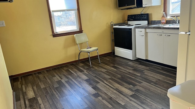 kitchen featuring white cabinets, dark wood-type flooring, sink, and electric range