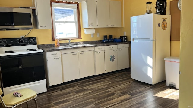 kitchen with sink, dark wood-type flooring, white cabinetry, range with electric stovetop, and white fridge