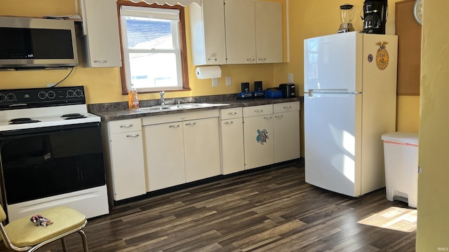 kitchen with electric stove, sink, dark wood-type flooring, white refrigerator, and white cabinets