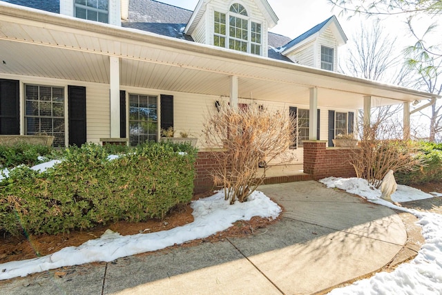 view of snow covered property entrance