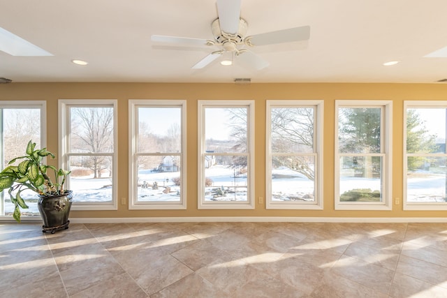 unfurnished sunroom with plenty of natural light and ceiling fan