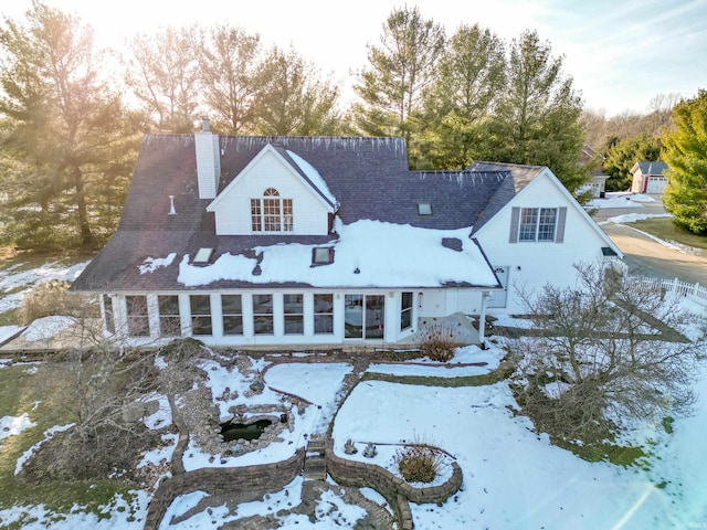 view of snow covered back of property