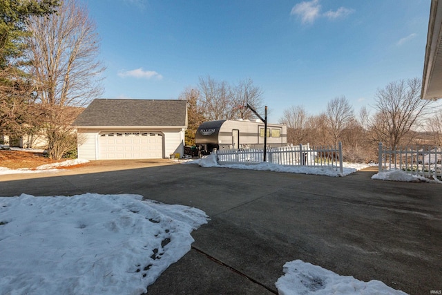 view of front of property featuring a garage and an outdoor structure