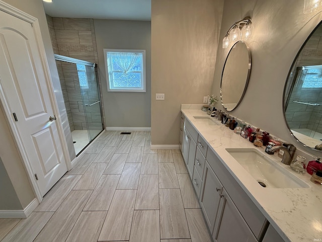 bathroom featuring vanity and an enclosed shower