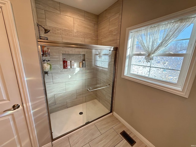 bathroom featuring tile patterned flooring and a shower with shower door