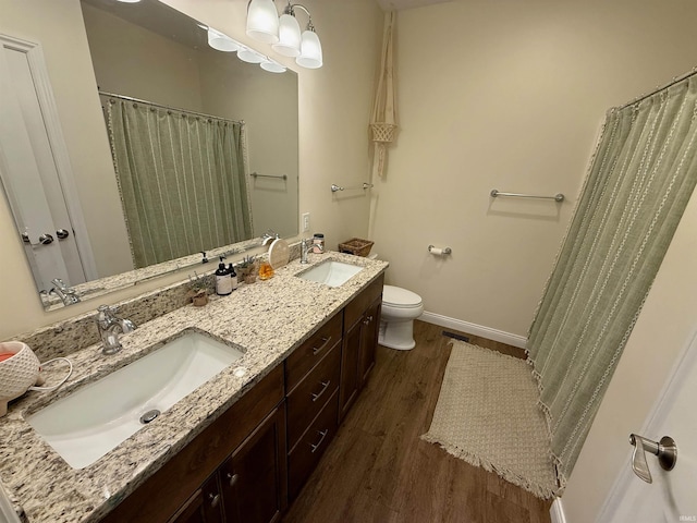 bathroom featuring vanity, toilet, and hardwood / wood-style floors