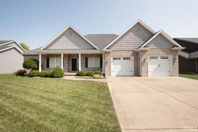 craftsman inspired home with a garage and a front yard