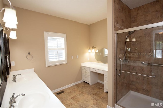 bathroom featuring vanity and a shower with door