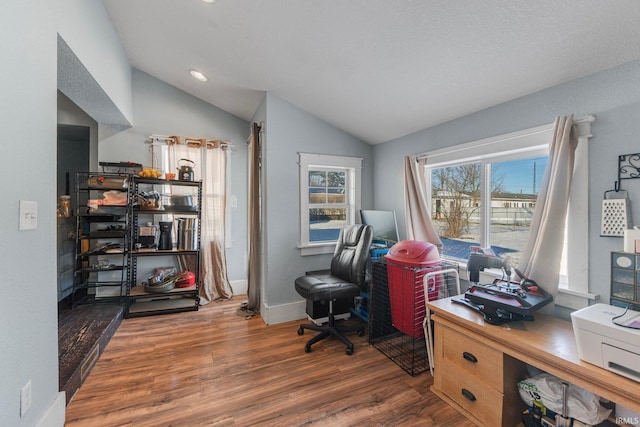 home office with vaulted ceiling and dark hardwood / wood-style flooring