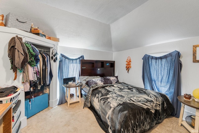 bedroom featuring lofted ceiling and light colored carpet