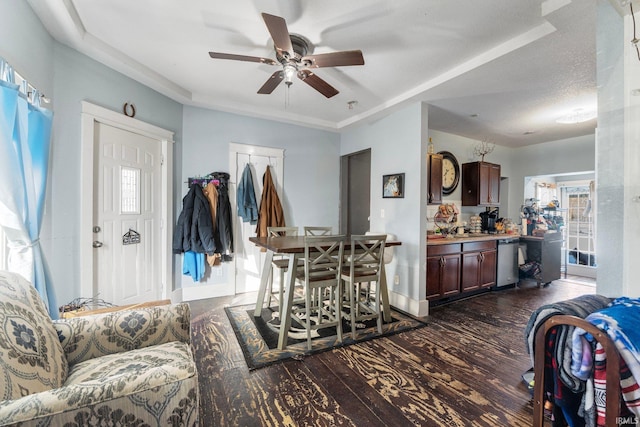 living room featuring ceiling fan, sink, dark hardwood / wood-style floors, and a textured ceiling