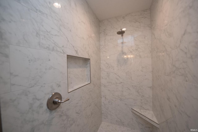 bathroom featuring tiled shower