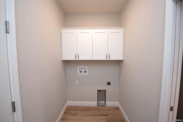 clothes washing area with electric dryer hookup, hookup for a washing machine, cabinets, and light wood-type flooring